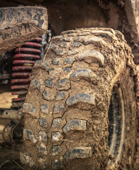 Off Roader Tire Closeup. SUV Wheel Covered by Clay and Mud. Motorsport Theme.